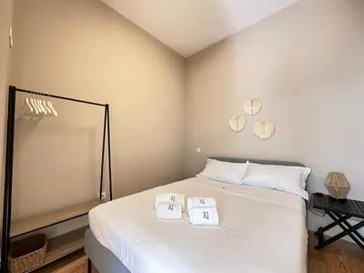 a bedroom with a bed with two towels on it at Magalhães Prime in Porto