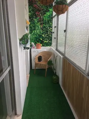 a small balcony with a green floor and a window at Art Gallery Apartment in Porto