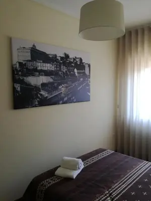 a bedroom with a bed with two towels on it at Art Gallery Apartment in Porto