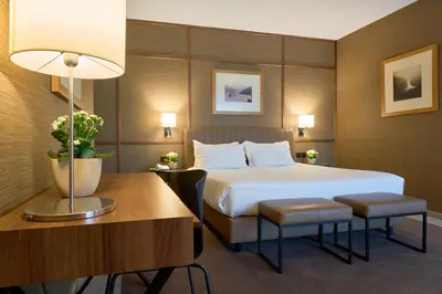 a hotel room with a bed and a table and a desk at Portus Cale Hotel in Porto