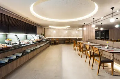 a restaurant with tables and chairs and a buffet at Portus Cale Hotel in Porto