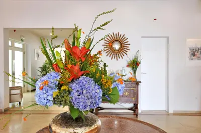 a vase filled with flowers on top of a table at Porto Domus Hotel in Porto