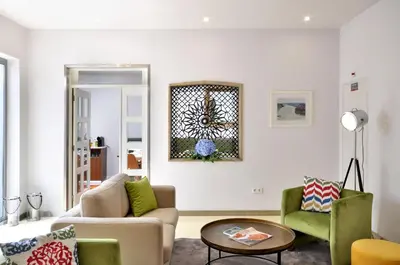 a living room with a couch and two chairs at Porto Domus Hotel in Porto