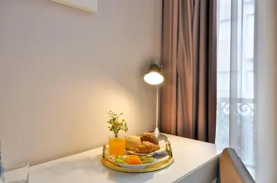 a plate of fruit and orange juice on a table at Porto Domus Hotel in Porto