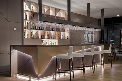 a bar with white stools in a restaurant at AC Hotel Porto by Marriott in Porto