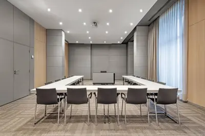 a conference room with a large table and chairs at AC Hotel Porto by Marriott in Porto