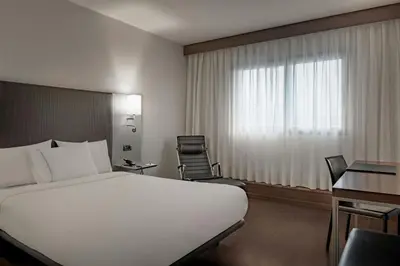 a hotel room with a bed and a desk and a window at AC Hotel Porto by Marriott in Porto