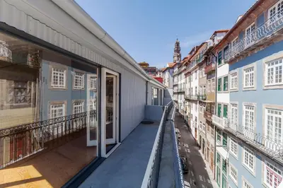 an empty balcony of a building with an open door at Villa Lóios by Casa do Conto in Porto