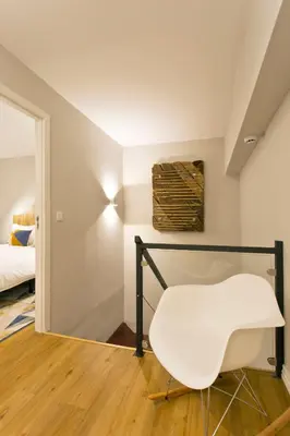 a white chair in a room with a bed at Duque de Loulé in Porto