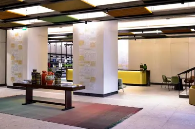 a large lobby with a table in the middle at Porto Palácio Hotel by The Editory in Porto