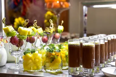 a row of glasses filled with different types of drinks at Porto Palácio Hotel by The Editory in Porto