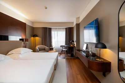 a hotel room with a bed and a desk at Porto Palácio Hotel by The Editory in Porto