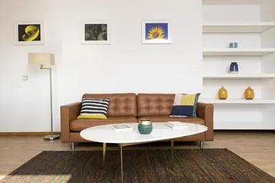 a living room with a brown couch and a coffee table at LV Premier Marques MQ2 in Porto