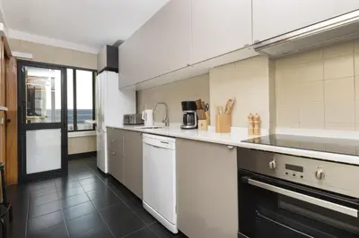 a kitchen with white appliances and a large window at LV Premier Marques MQ2 in Porto