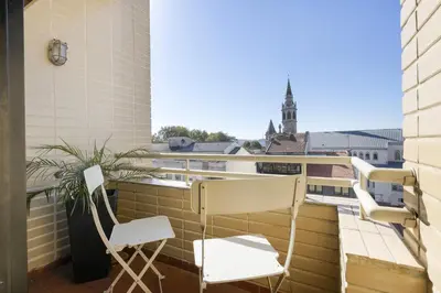 a balcony with two chairs and a view of a building at LV Premier Marques MQ2 in Porto