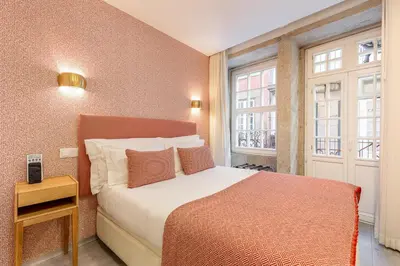 a hotel room with a bed and a window at YOUROPO - Ribeira Porto in Porto