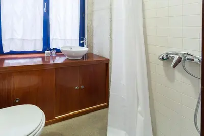 a bathroom with a sink and a toilet and a shower at Flores Studio in Porto