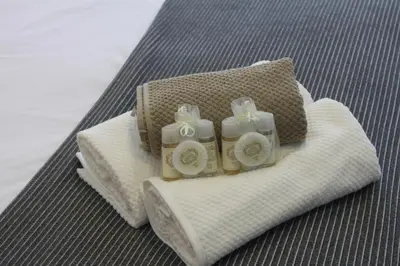two wrapped towels with bows on top of them at Flores Central in Porto