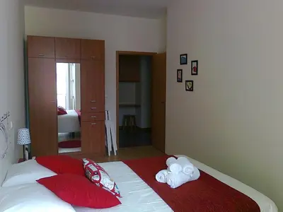 a bedroom with a bed with red and white pillows at Formosa Oporto Apartments Group in Porto