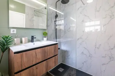 a bathroom with a sink and a shower at Ren Feb26 Clerigos Retreat in Porto