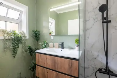a bathroom with a sink and a mirror at Ren Feb26 Clerigos Retreat in Porto