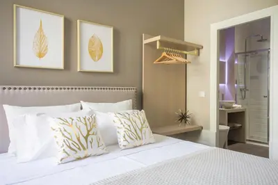 a bedroom with a white bed with two pillows at Gil Vicente - Charming Guesthouse in Porto