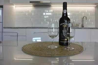 a bottle of wine and two wine glasses on a table at Casa Paillard, by Flat in Porto in Porto