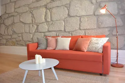 a living room with a red couch and a table at Casa Paillard, by Flat in Porto in Porto