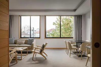 a living room with a couch and a table and chairs at ClipHotel in Vila Nova de Gaia