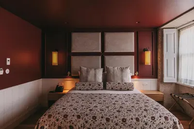 a bedroom with a large bed with two pillows at Gran Cruz House in Porto