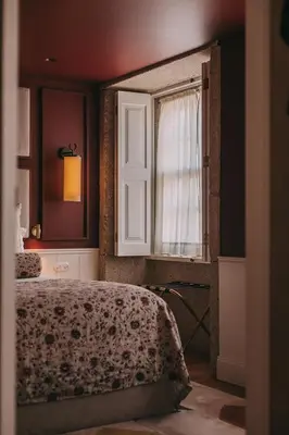 a bedroom with a bed and a window at Gran Cruz House in Porto