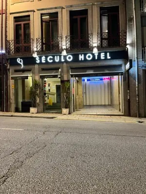 a sign for a hotel on the side of a street at Seculo Hotel in Porto
