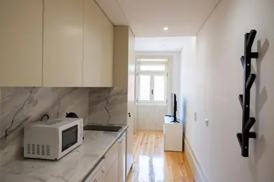 a kitchen with a microwave on top of a counter at Lively Getaway Apartment in Porto