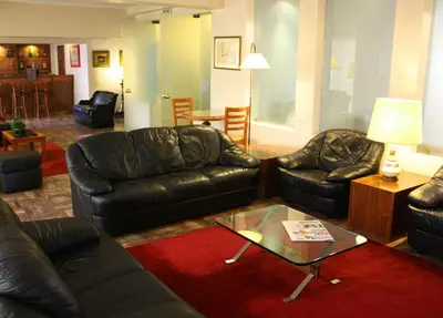 a living room with two leather couches and a coffee table at Hotel Vice-Rei in Porto