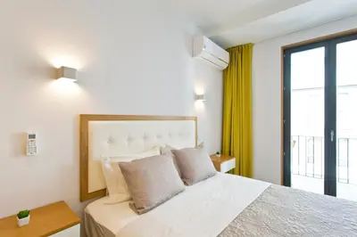 a bedroom with a large bed and a window at OTF- Porto Centro in Porto