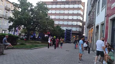 a group of people walking down a street at OTF- Porto Centro in Porto