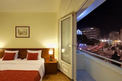 a hotel room with a bed and a window with a view at Vera Cruz Porto Downtown Hotel in Porto