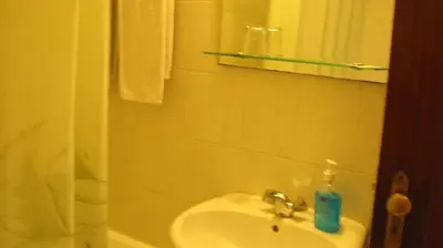 a bathroom with a sink and a mirror at Residencial Porto Novo - Alojamento Local in Porto