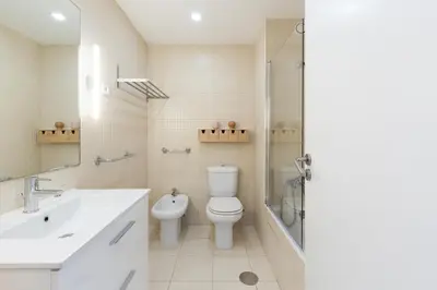 a bathroom with a toilet and a sink and a shower at Aposentus - Arrábida Studio in Vila Nova de Gaia