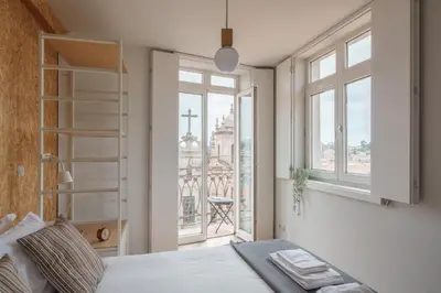 a bedroom with a bed and a large window at Shining View Apartments in Porto