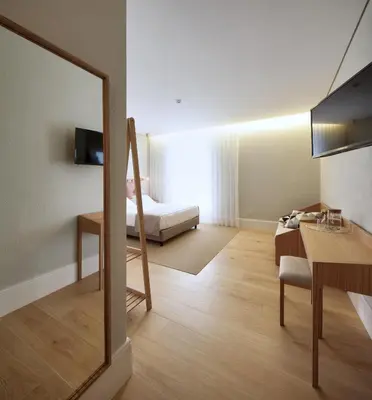a room with a bedroom with a bed and a mirror at The Rex Hotel Porto - Mansion House - Private Parking in Porto