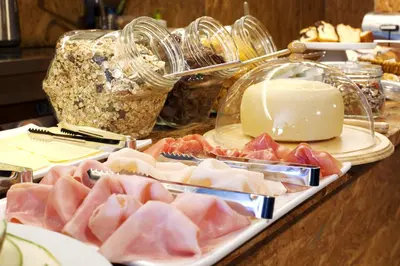 a buffet of meats and cheese on a table at Cale Guest House in Porto