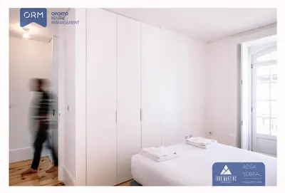 a person walking in a room with a bed at ORM - Virtudes Apartment in Porto