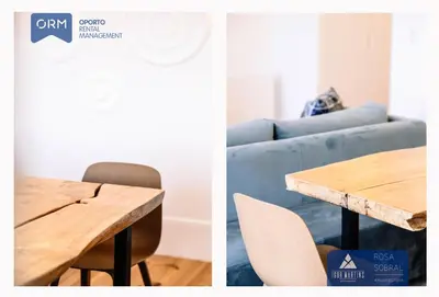 a dining room table and a blue couch at ORM - Virtudes Apartment in Porto