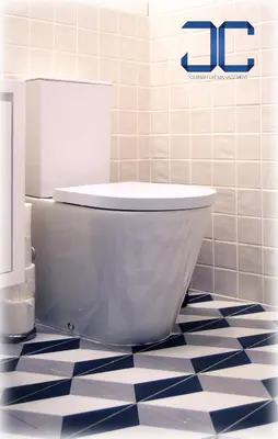 a toilet in a bathroom with a tiled floor at #Four Apartment by JC in Porto