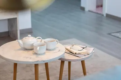 two tables with cups and a tea pot on them at LovelyStay - Boavista Cozy Apartment in Porto