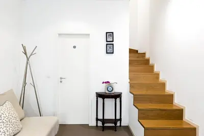 a stairway with a white wall and a white stair case at Historical Center - Taipas Apartments in Porto