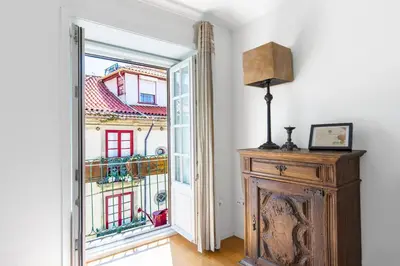 a room with a large window and a wooden cabinet at Historical Center - Taipas Apartments in Porto