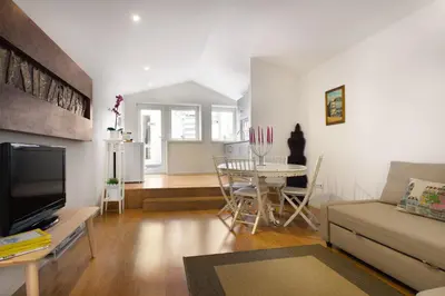 a living room with a couch and a table at Historical Center - Taipas Apartments in Porto