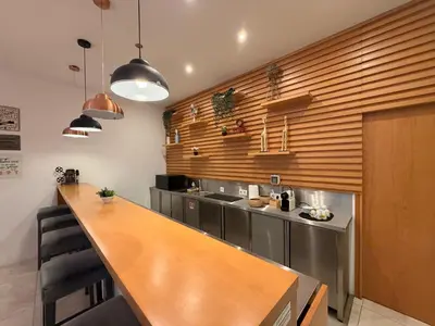 a bedroom with a desk and a tv on the wall at Mystay Porto Batalha in Porto